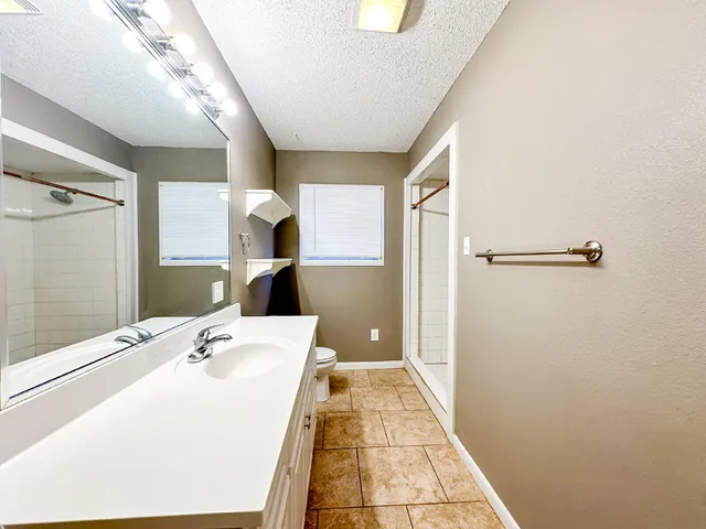 a bathroom with a sink and shower