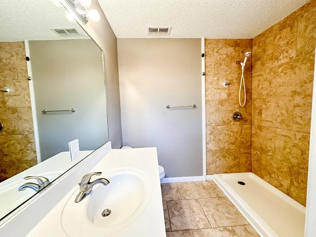 a bathroom with a tub sink and shower