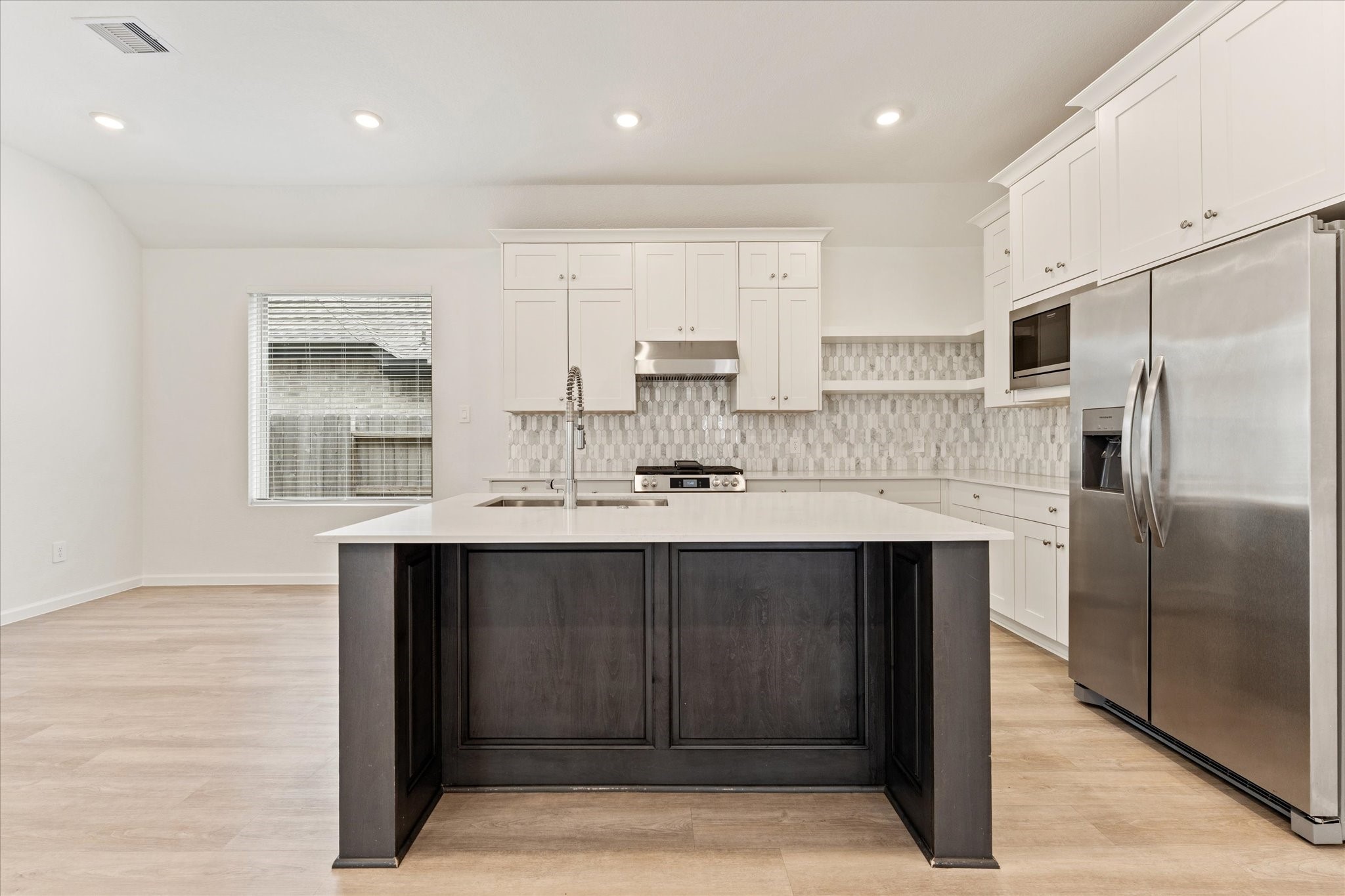 15520 Sunset Maple Court Conroe, TX 77302 - Photo 9 of 46 a kitchen with a sink stainless steel appliances and cabinets
