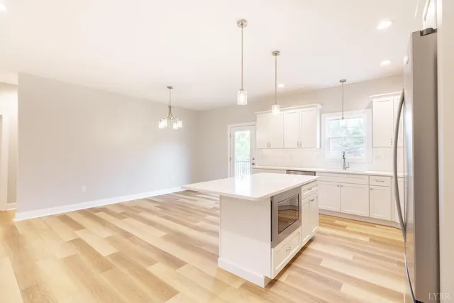 a kitchen with white cabinets and a stove