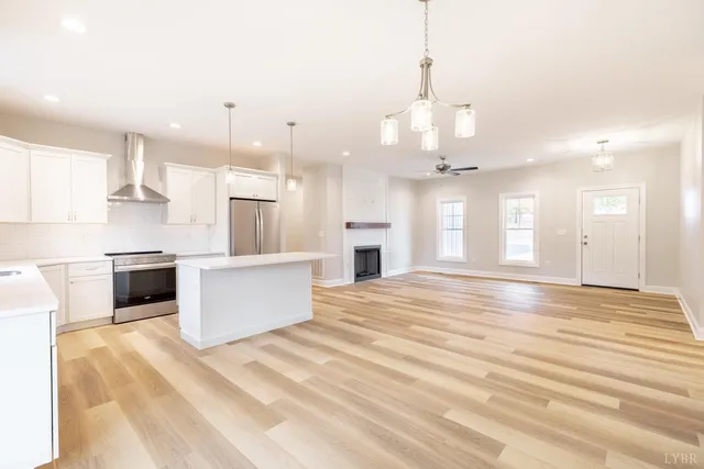 a view of a kitchen and an empty room