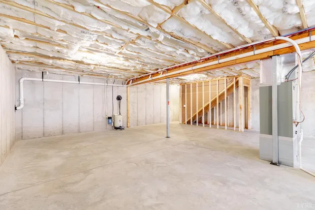 an empty room with closet and a chandelier fan