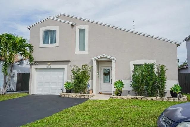 a front view of a house with a yard and garage