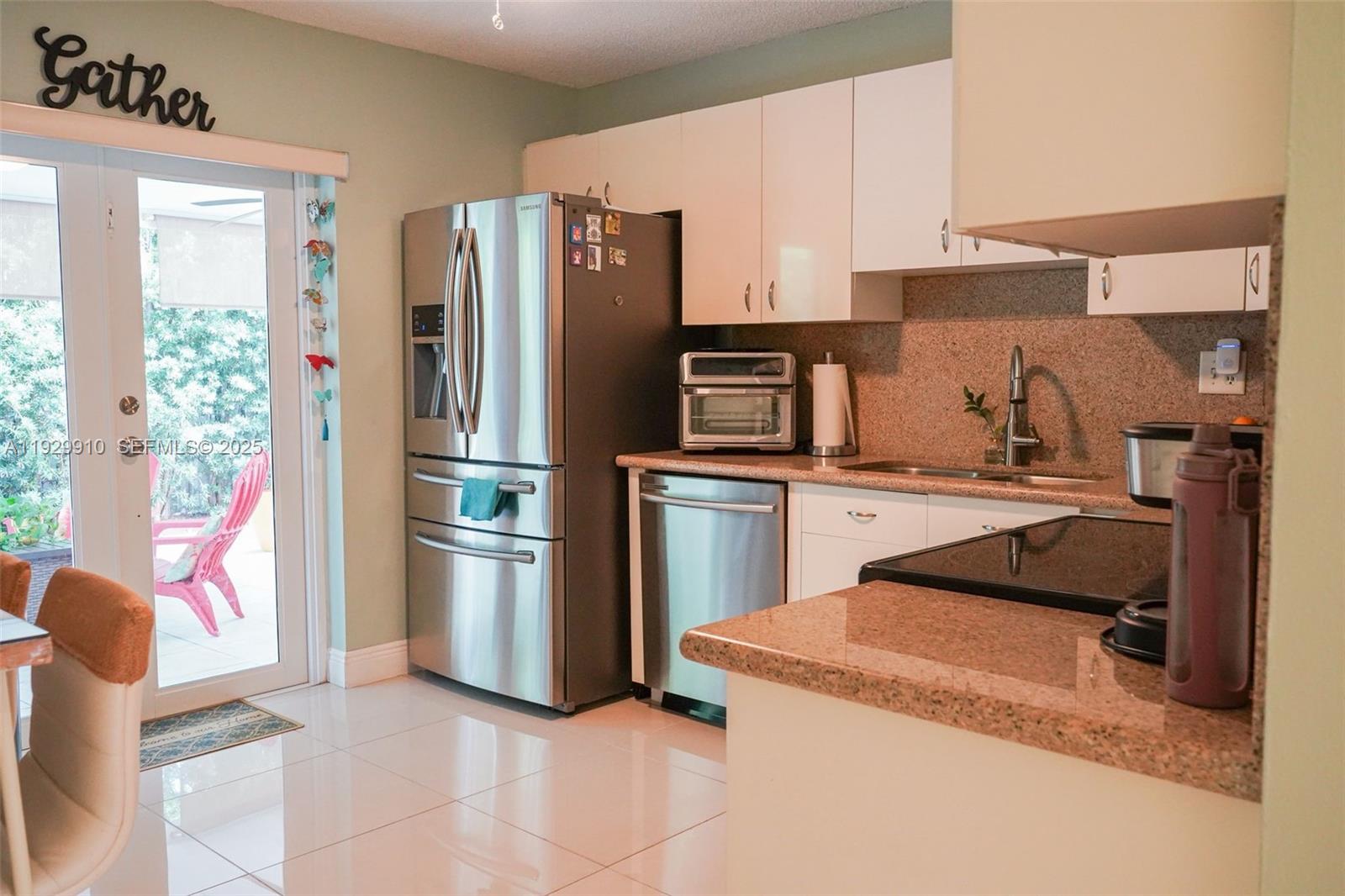 19907 Northwest 67th Court Hialeah, FL 33015 - Photo 15 of 53 a kitchen with a sink appliances and cabinets