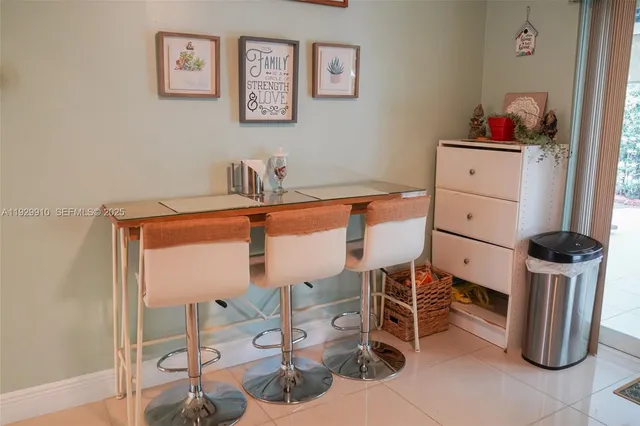 a kitchen with stainless steel appliances kitchen island granite countertop a refrigerator and a stove top oven