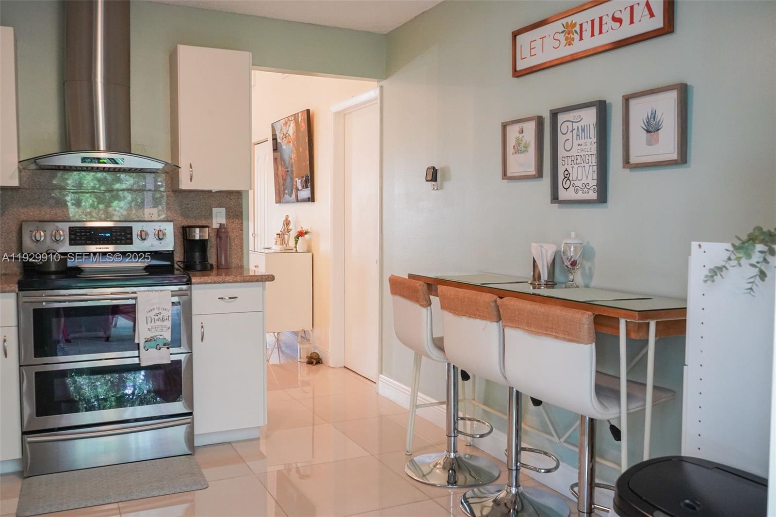 19907 Northwest 67th Court Hialeah, FL 33015 - Photo 20 of 53 a kitchen with stainless steel appliances kitchen island granite countertop a refrigerator and a stove top oven