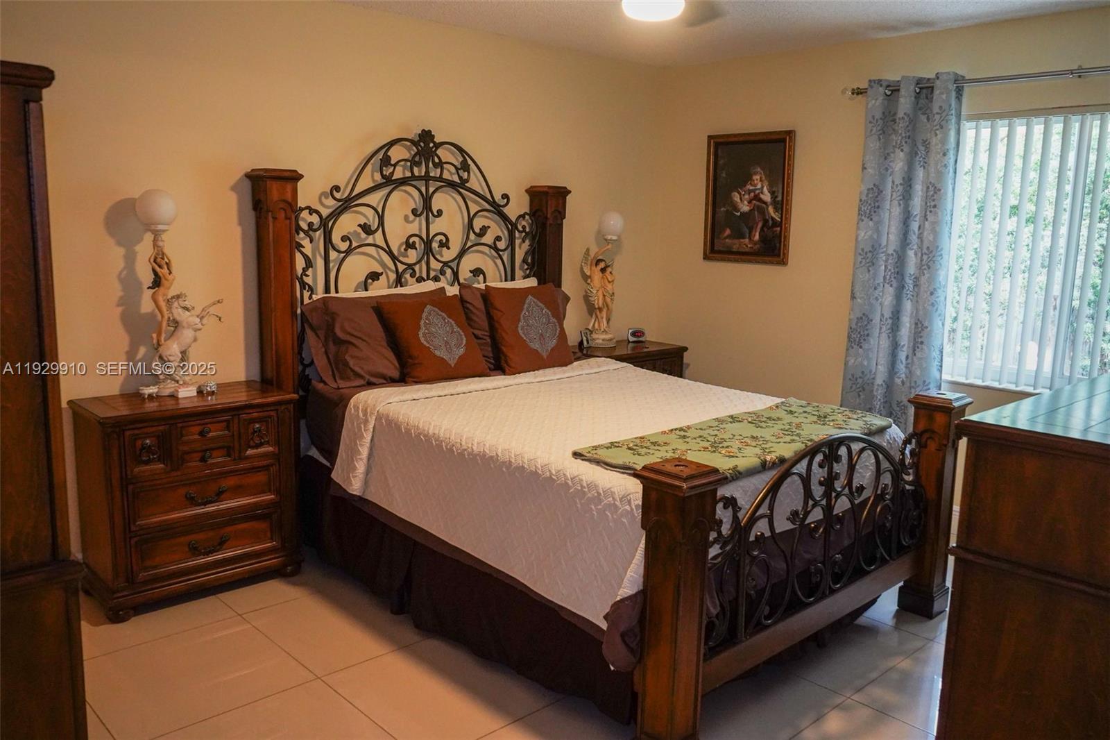 19907 Northwest 67th Court Hialeah, FL 33015 - Photo 21 of 53 a bedroom with a bed and a window