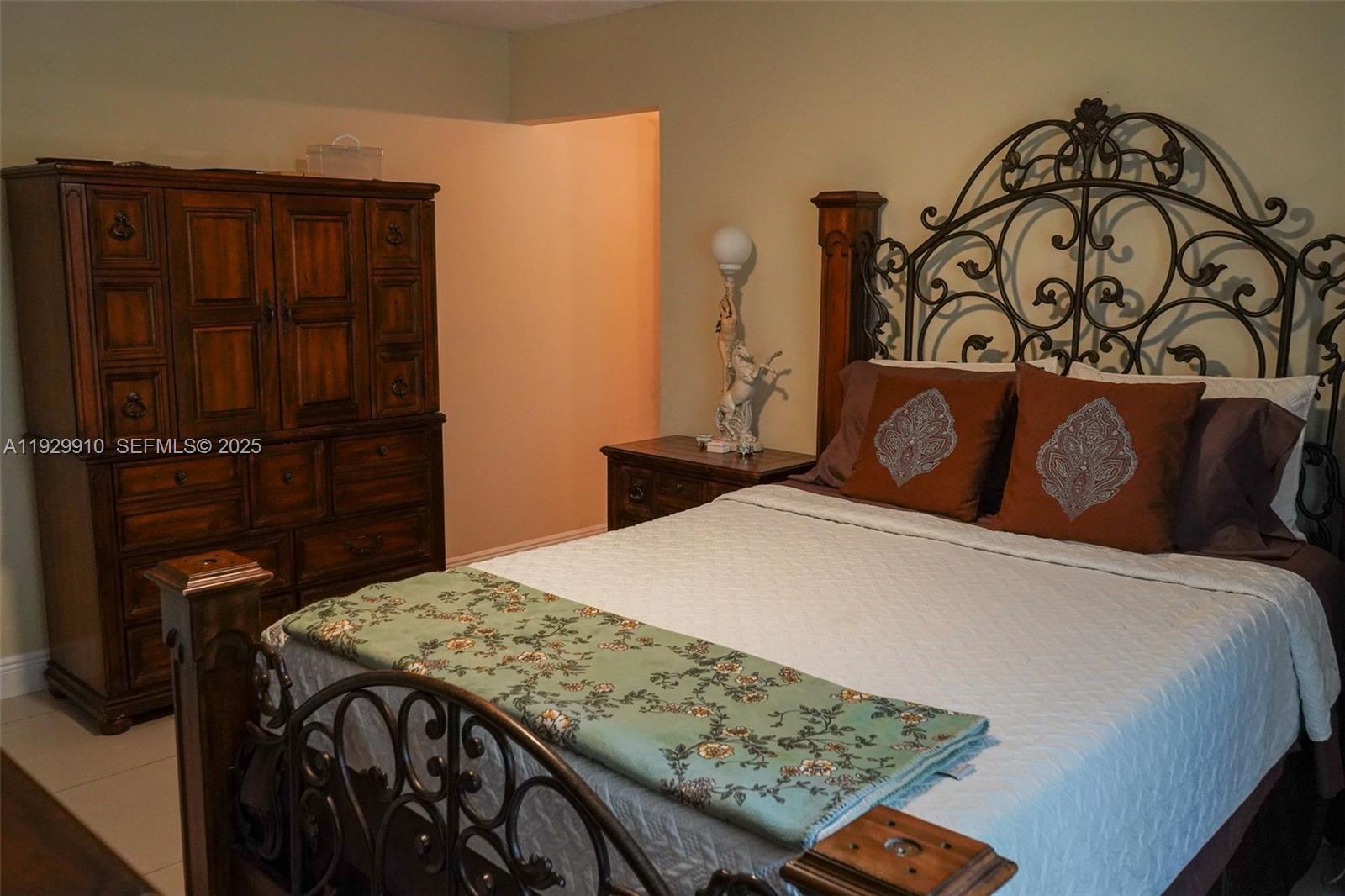 19907 Northwest 67th Court Hialeah, FL 33015 - Photo 22 of 53 a bedroom with a bed and a table in it