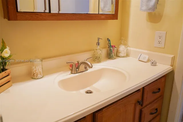 a bathroom with a sink a toilet a shower curtain and a mirror