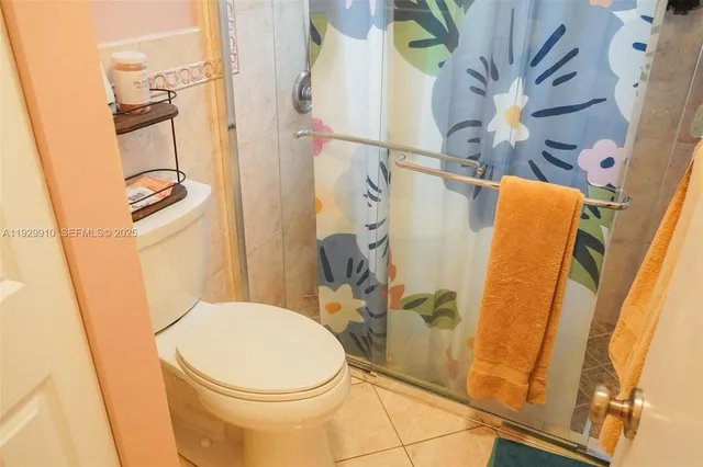 a bathroom with a toilet and shower