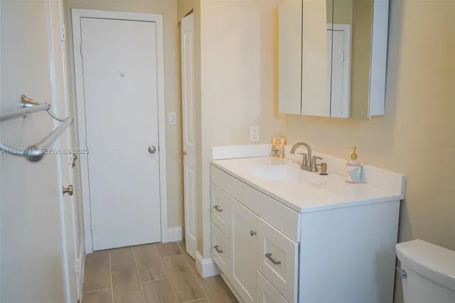 a white toilet sitting next to a bathroom sink