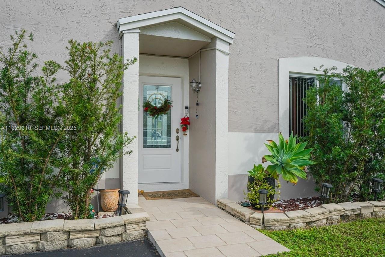 19907 Northwest 67th Court Hialeah, FL 33015 - Photo 4 of 53 a front view of a house with trees