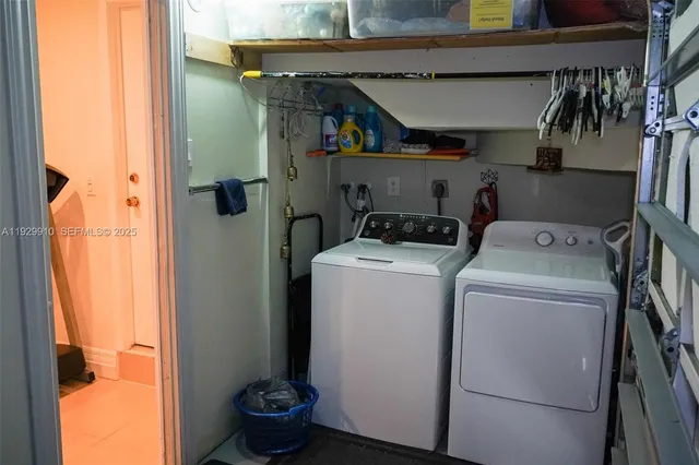 a view of storage and utility room with washer and dryer
