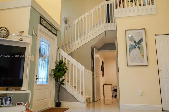 a view of an entryway with wooden floor and livingroom