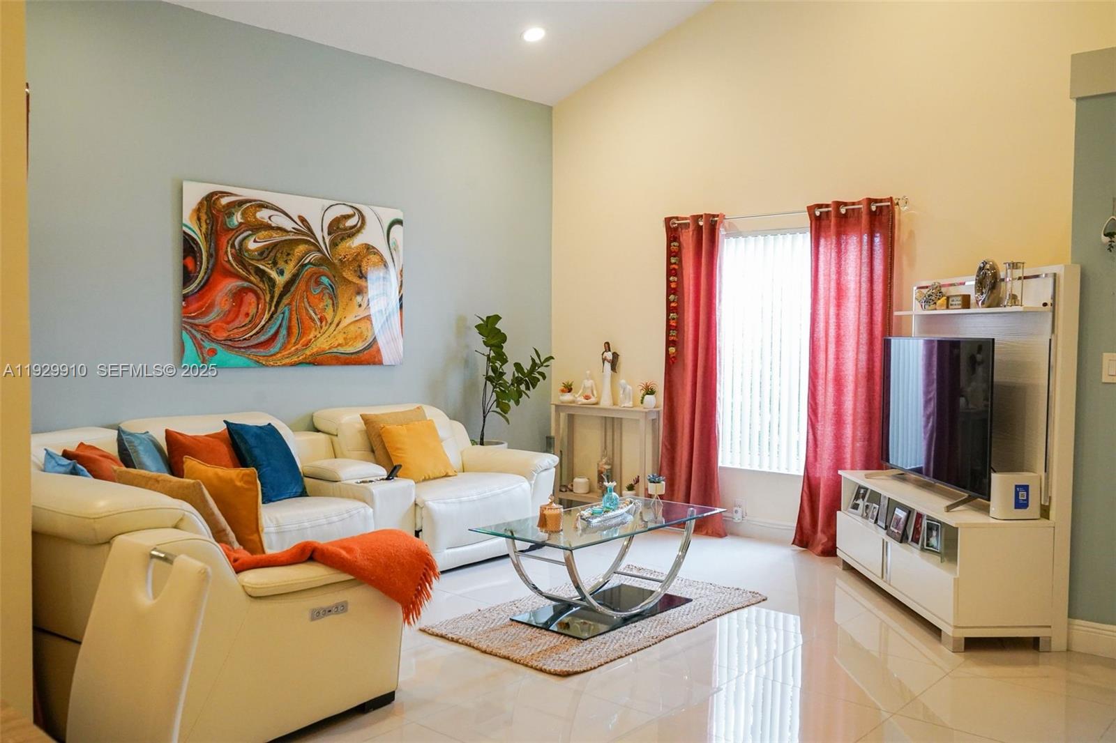 19907 Northwest 67th Court Hialeah, FL 33015 - Photo 7 of 53 a living room with furniture a flat screen tv and a wall painting