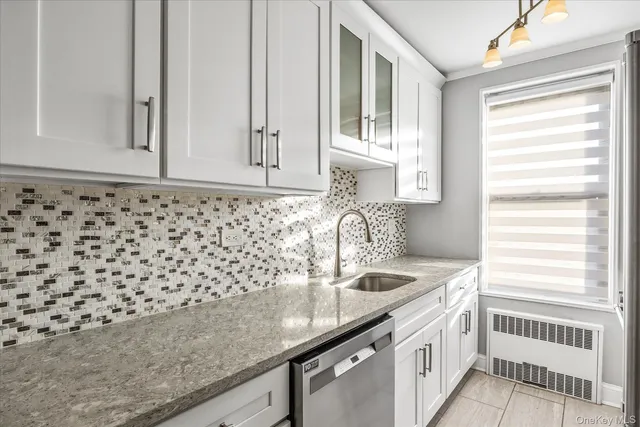 a bathroom with a sink a vanity and a window