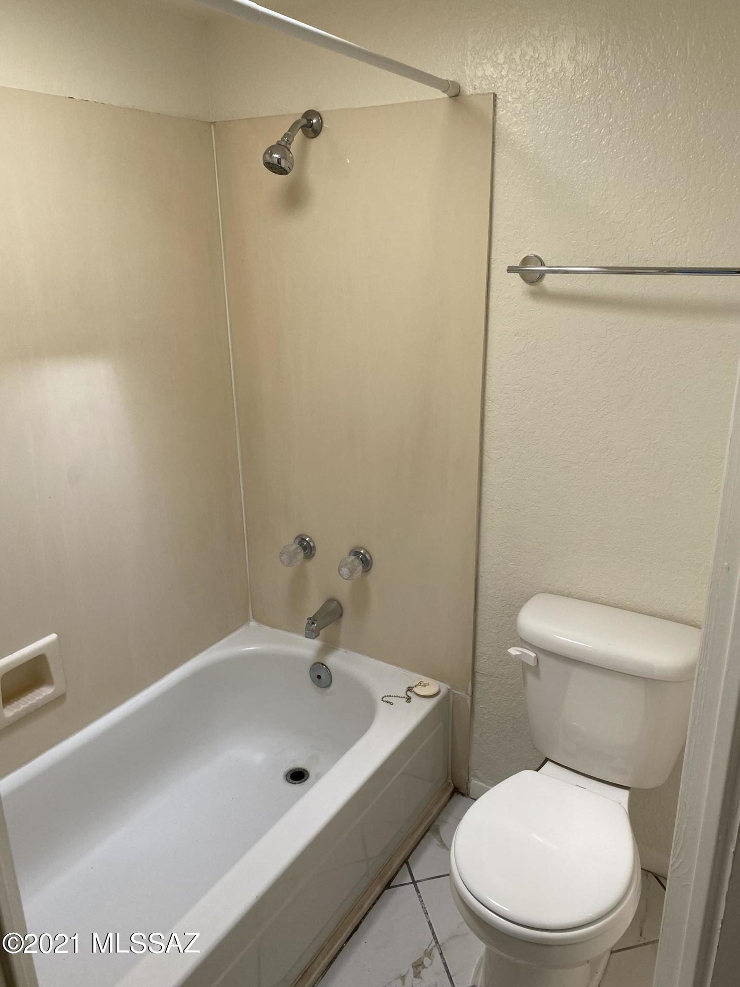 210 East Pastime Road Tucson, AZ 85705 - Photo 20 of 29 a white toilet sitting next to a bath tub