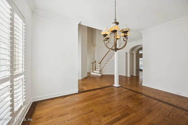 an aerial view of a house with outdoor space and a garden