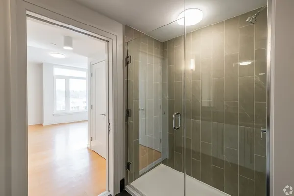 a bathroom with a shower and a sink