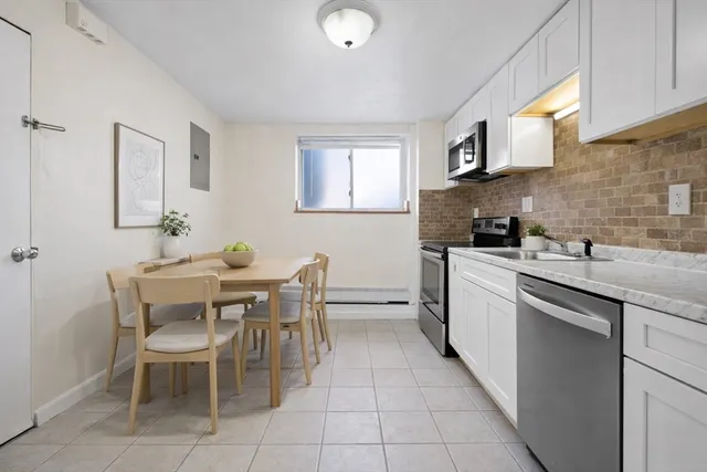 a kitchen with a sink dining table and chairs
