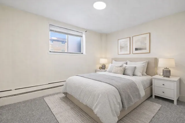 a bedroom with a bed and a painting on the wall