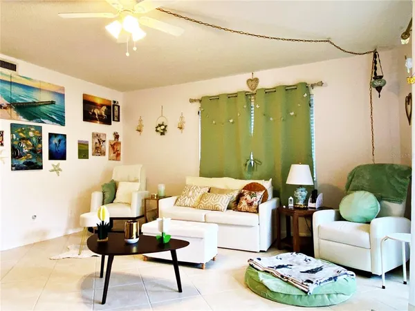 a living room with furniture and a potted plant