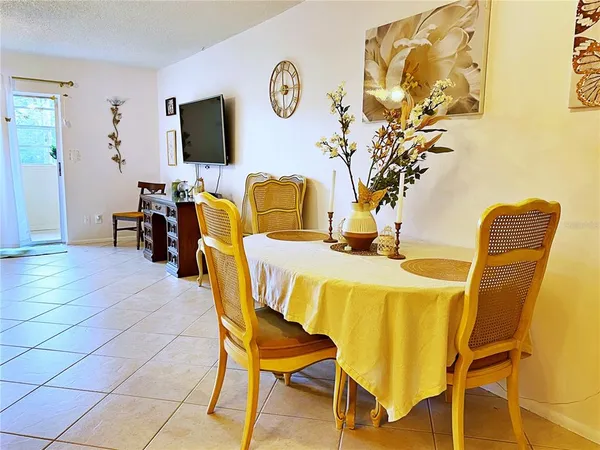 a dining room with furniture and a flat screen tv