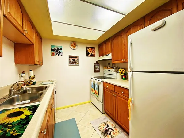 a kitchen with stainless steel appliances a stove a sink and a refrigerator