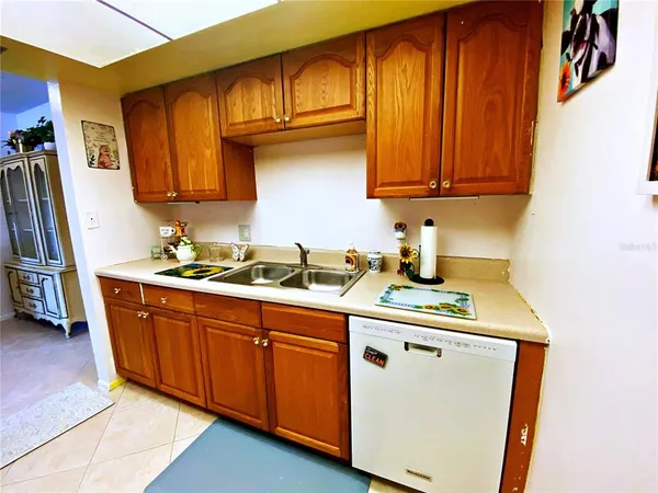 a kitchen with stainless steel appliances granite countertop wooden cabinets a sink and a dishwasher
