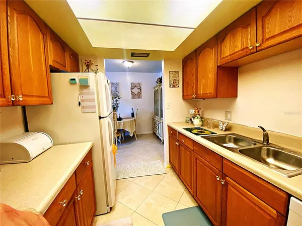a kitchen with a sink appliances and cabinets