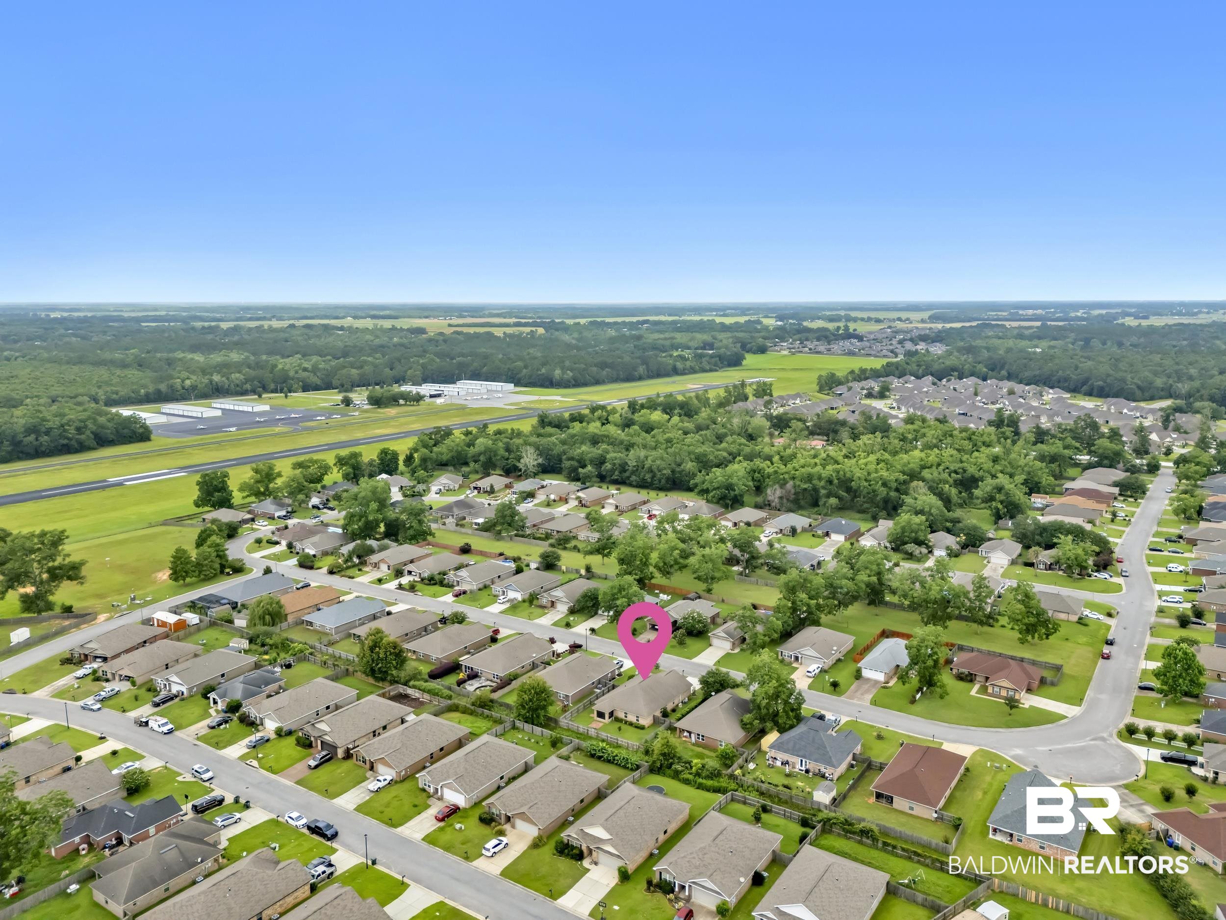 1704 Abbey Loop Foley, AL 36535 - Photo 37 of 38 Aerial depiction of a residential neighborhood with single-story homes and a clear blue sky