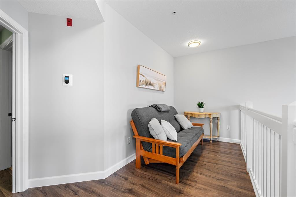 4784 Central Boulevard, Unit 22 Jupiter, FL 33458 - Photo 11 of 18 a bedroom with a bed and wooden floor