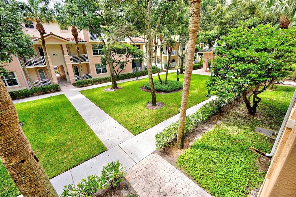 4784 Central Boulevard, Unit 22 Jupiter, FL 33458 - Photo 14 of 18 a view of a house with a yard