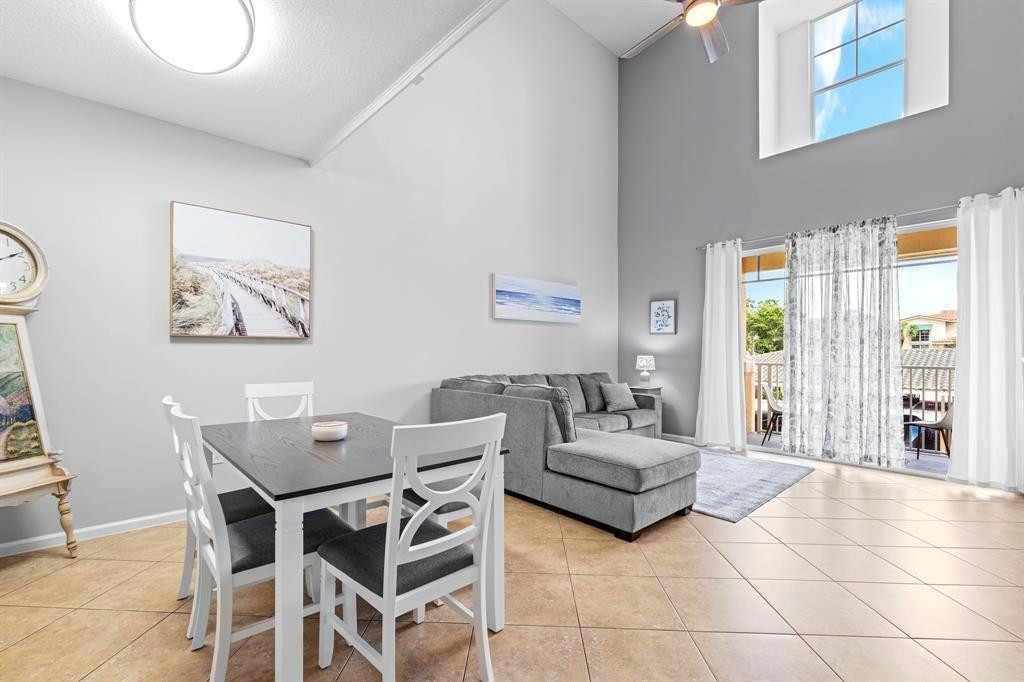 4784 Central Boulevard, Unit 22 Jupiter, FL 33458 - Photo 2 of 18 a living room with furniture and a large window