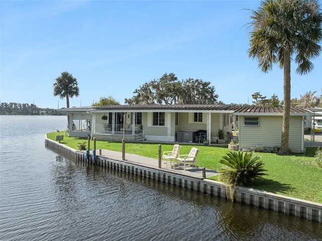 a view of a house with pool and a yard