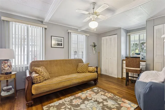 a living room with furniture ceiling fan and a rug