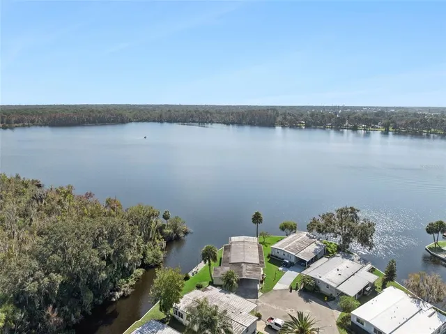 a view of lake from balcony with outdoor seating