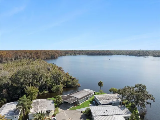 a view of terrace with lawn chairs and iron fence