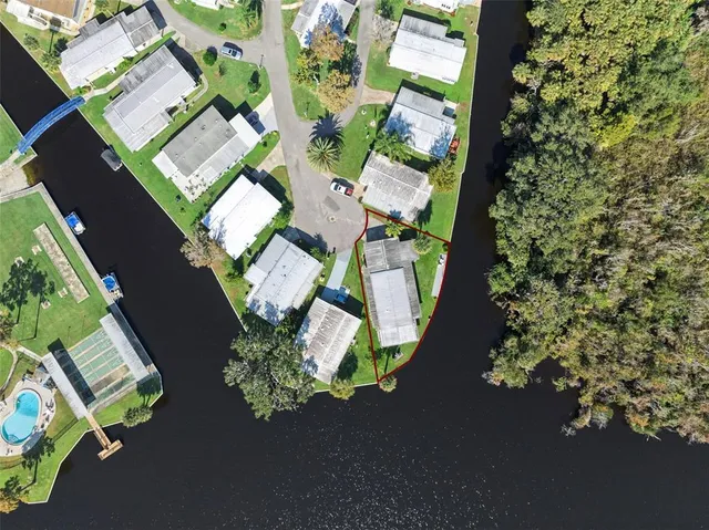 an aerial view of a house with a yard and garden