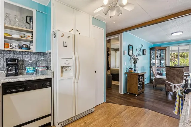 a view of kitchen with stainless steel appliances granite countertop cabinets and a refrigerator