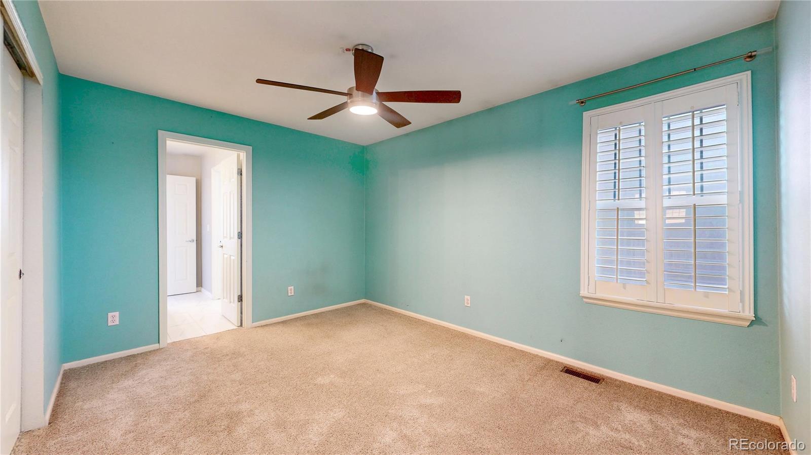 10797 Hickory Ridge Street Highlands Ranch, CO 80126 - Photo 19 of 42 an empty room with closet and windows