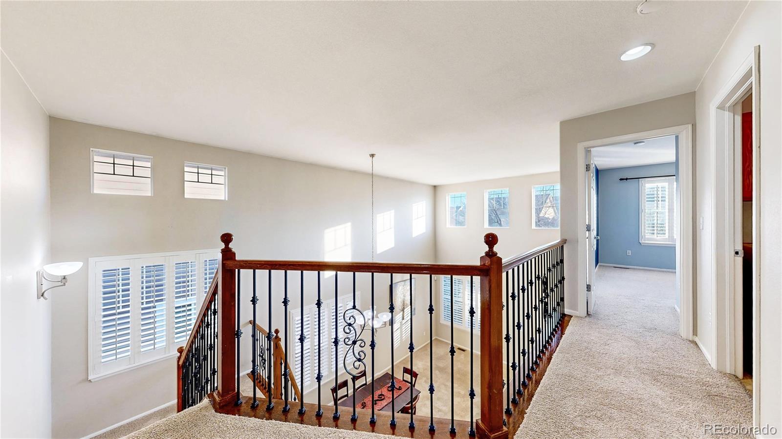 10797 Hickory Ridge Street Highlands Ranch, CO 80126 - Photo 20 of 42 a view of a hallway with wooden floor and stairs