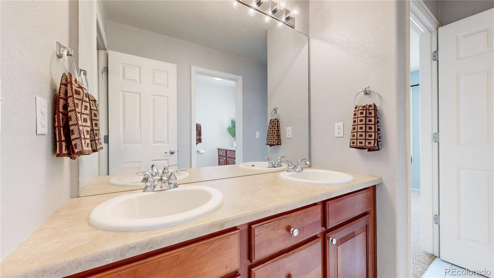 10797 Hickory Ridge Street Highlands Ranch, CO 80126 - Photo 24 of 42 a bathroom with a sink and a mirror
