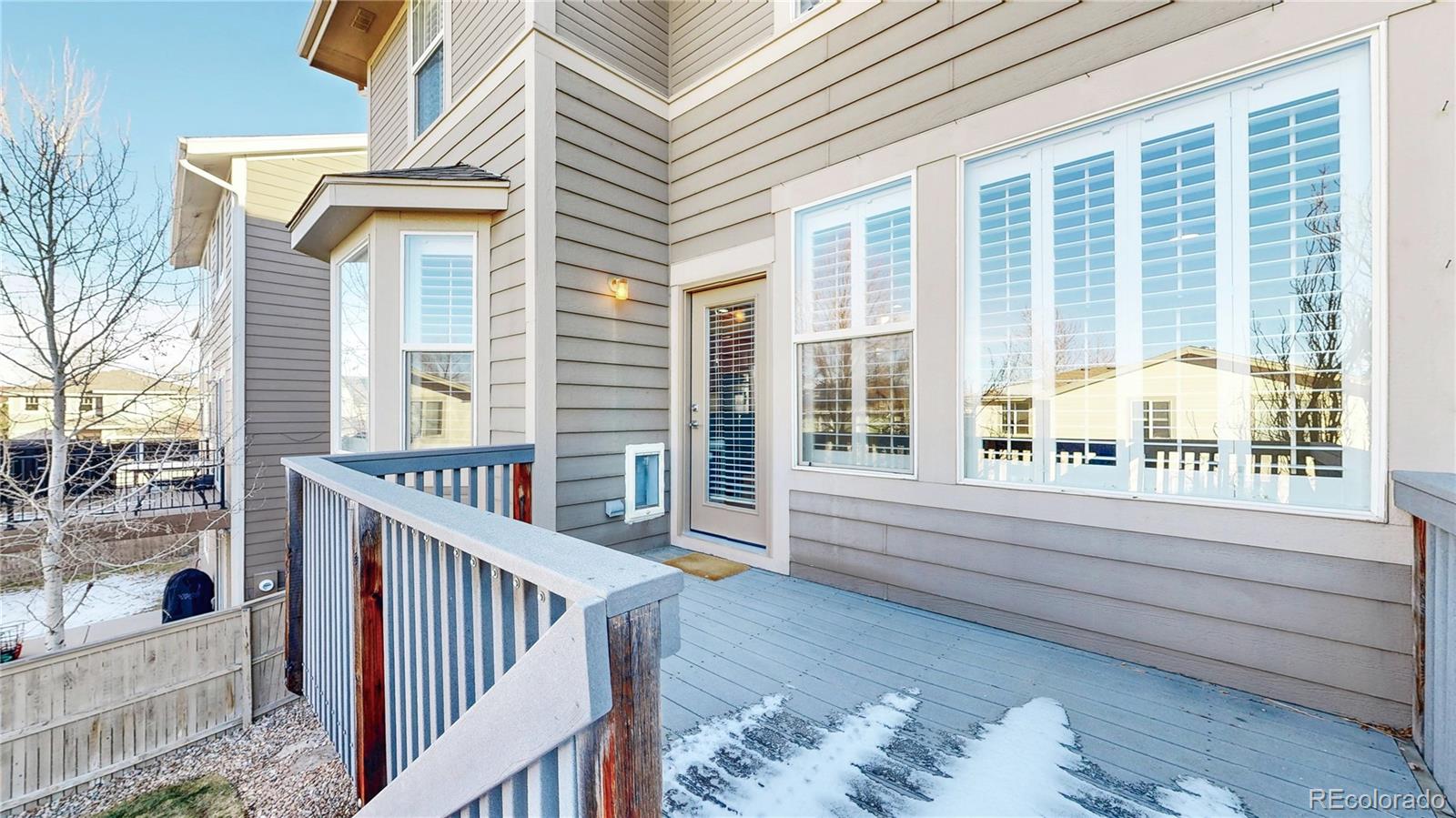 10797 Hickory Ridge Street Highlands Ranch, CO 80126 - Photo 30 of 42 a view of a porch with a bench next to a yard