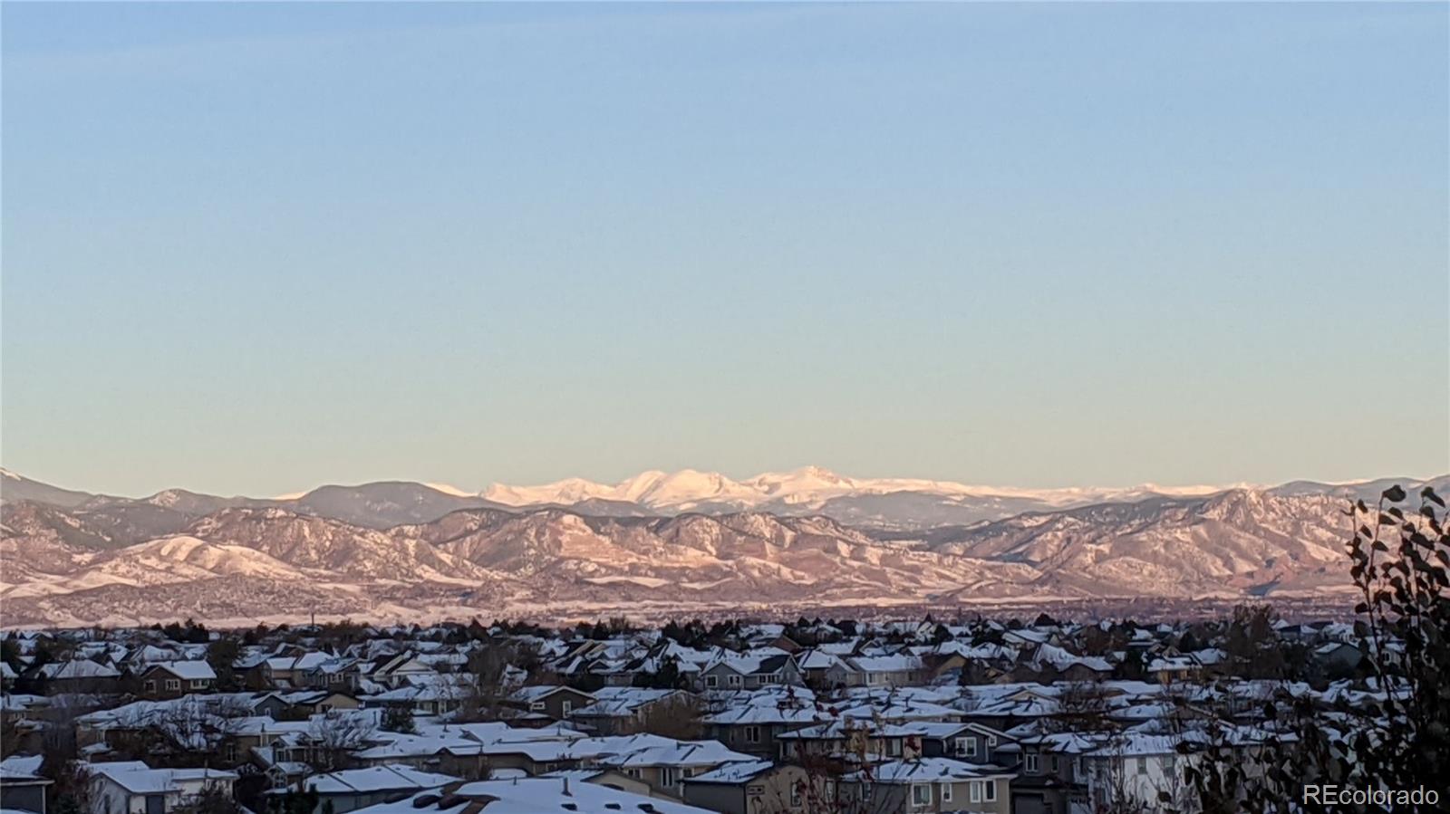 10797 Hickory Ridge Street Highlands Ranch, CO 80126 - Photo 38 of 42 a view of a mountain range in a cloudy sky