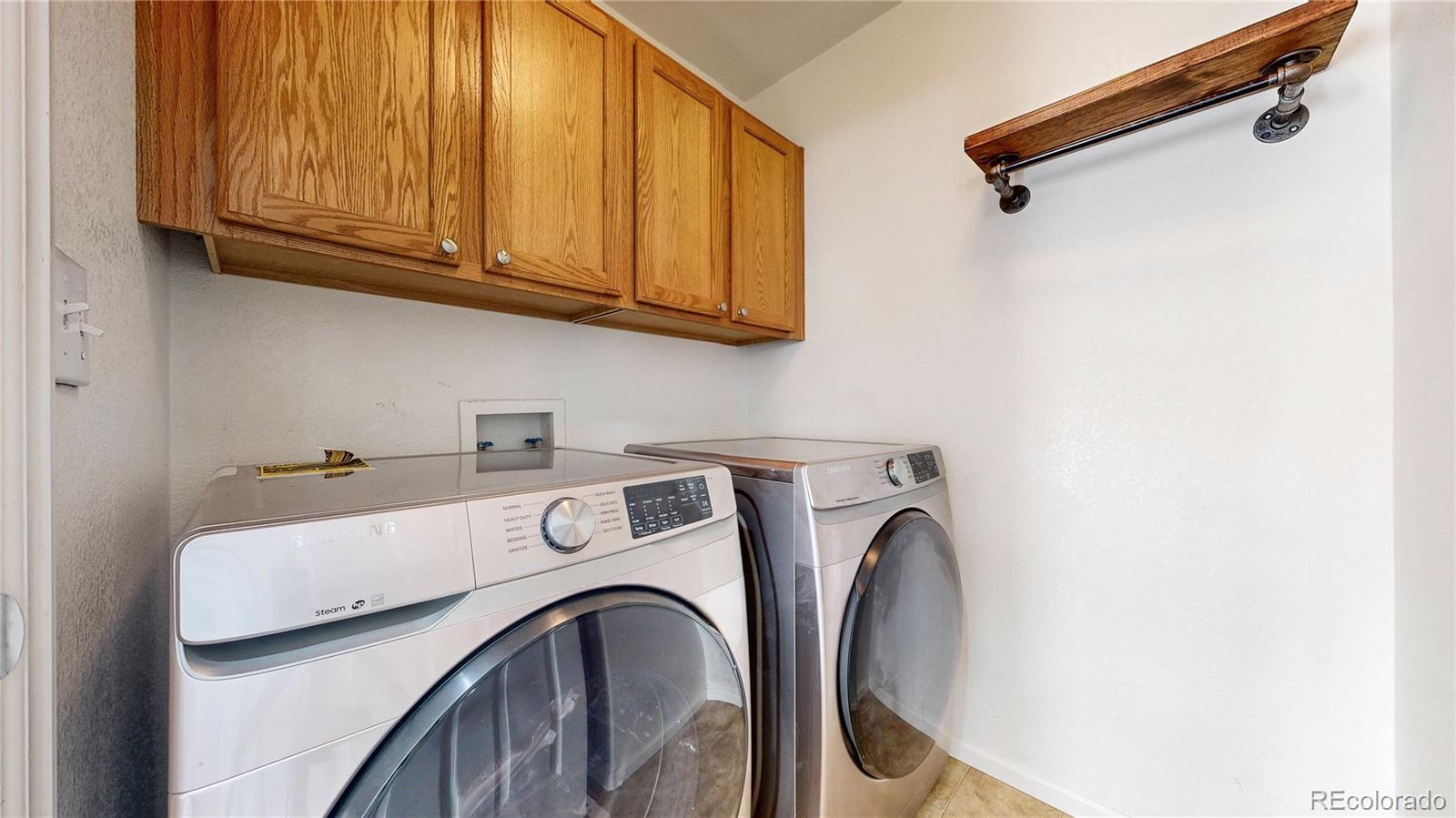 10797 Hickory Ridge Street Highlands Ranch, CO 80126 - Photo 40 of 42 a utility room with dryer and washer