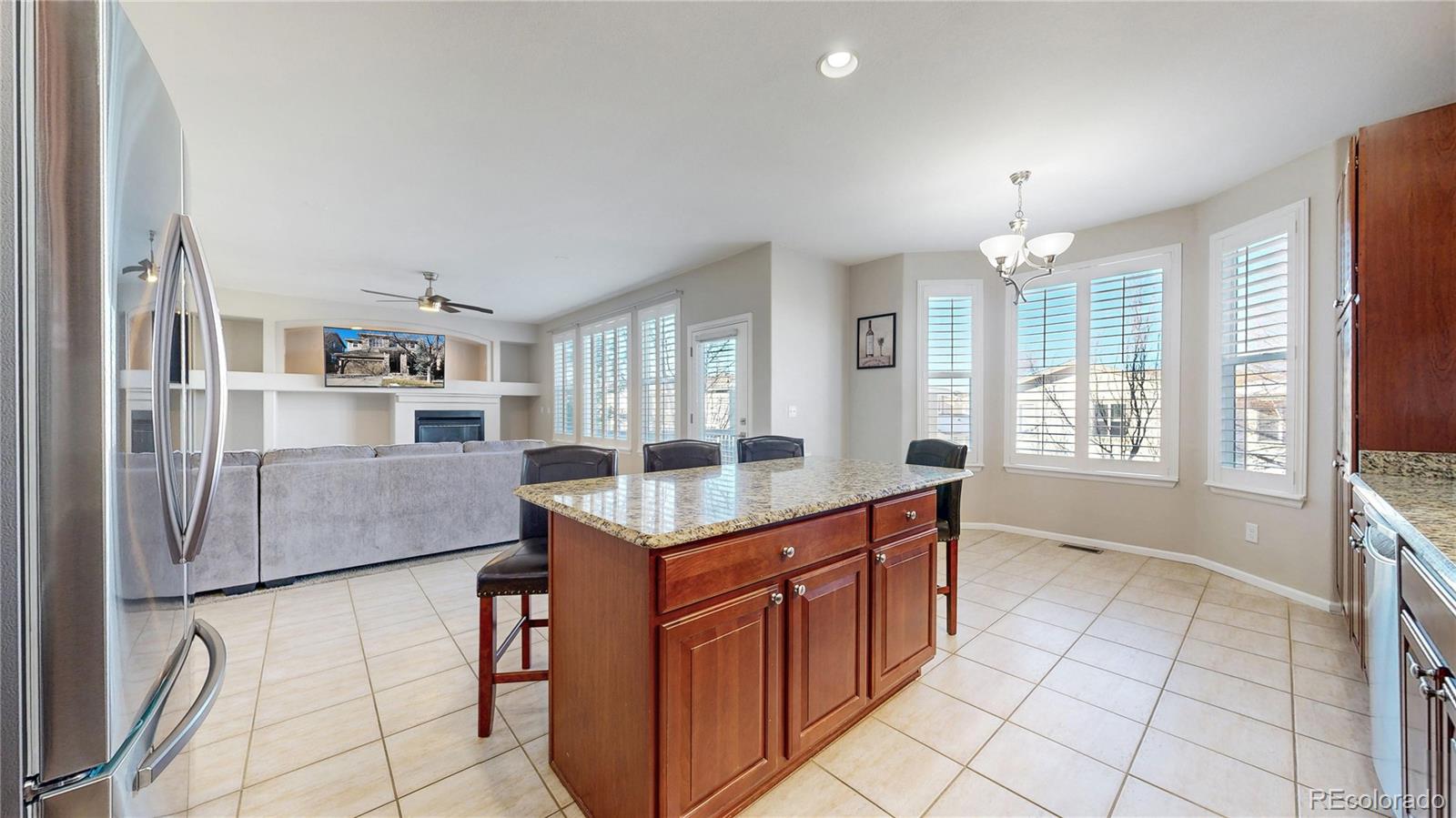 10797 Hickory Ridge Street Highlands Ranch, CO 80126 - Photo 8 of 42 a kitchen with stainless steel appliances granite countertop a refrigerator and a stove