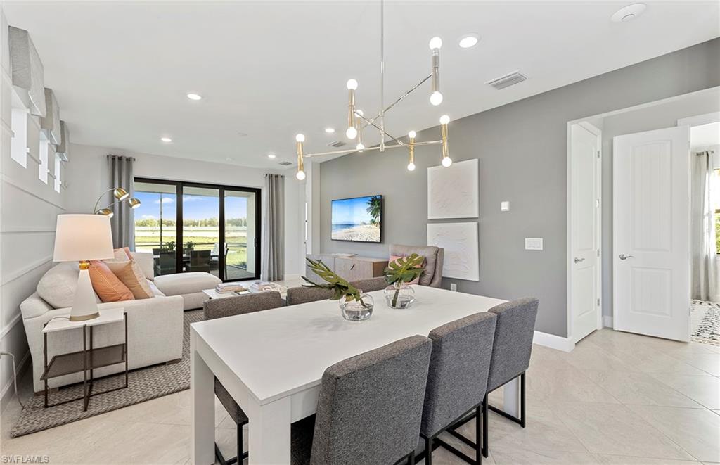 2142 Yellowfin Circle Naples, FL 34114 - Photo 11 of 31 a large white kitchen with a table and chairs