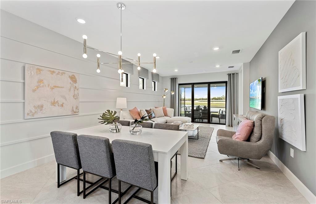 2142 Yellowfin Circle Naples, FL 34114 - Photo 12 of 31 a large kitchen with a table and chairs