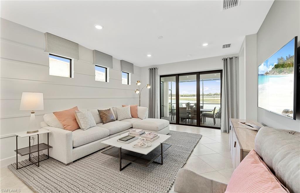 2142 Yellowfin Circle Naples, FL 34114 - Photo 13 of 31 a living room with furniture and a large window